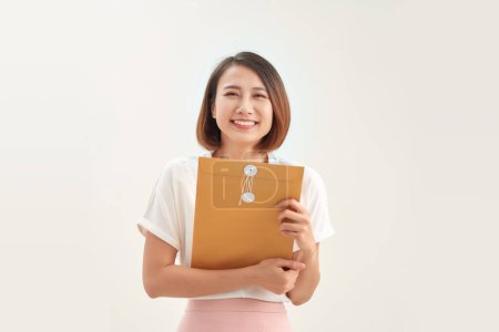 Photo for Businesswoman holding brown paper envelope in office - Royalty Free Image