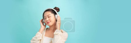 Photo for Happy asian girl throws party, dance in rhythm of music. Panorama - Royalty Free Image