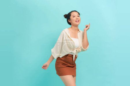 Photo for Happy attractive woman dancing and having fun, raising hands up carefree - Royalty Free Image