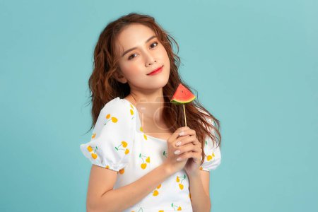 Photo for Photo of pretty cheerful girl hold fresh watermelon, with toothy smile isolated on blue banner background - Royalty Free Image