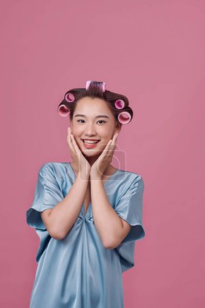 Photo for Portrait of young woman wearing hair rollers - Royalty Free Image