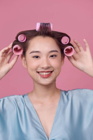 Photo for Portrait of beautiful woman with hair curlers posing isolated - Royalty Free Image