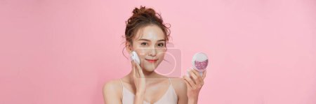 Photo for Gorgeous woman applying her cheek with dry powder - Royalty Free Image