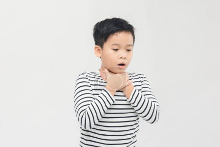 Photo for A schoolboy has a sore throat, holds his hands by the throat. Panorama - Royalty Free Image