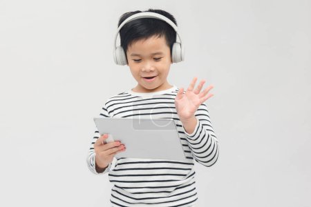 Photo for Photo of happy boy using tablet over white background - Royalty Free Image