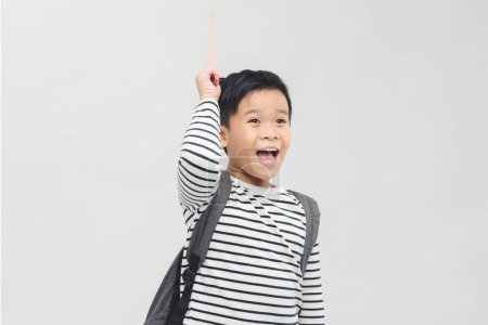 Photo for A handsome schoolboy raises a pencil up, on a white banner background - Royalty Free Image