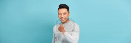 Photo for Adult Asian man showing success gesture with his hand - Royalty Free Image