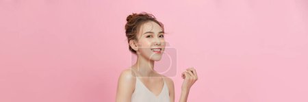Photo for Portrait of attractive asian girl with beauty natural skin isolated on pink background - Royalty Free Image