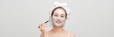 Téléchargez les photos : Spa girl applying facial mask. Beauty treatments. panorama - en image libre de droit
