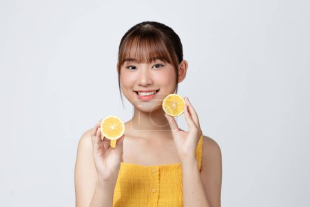 Photo for Energy. Close up of beautiful young woman with lemon slices on white background. - Royalty Free Image
