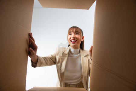 Photo for Woman with open box, view from inside. Surprise. - Royalty Free Image