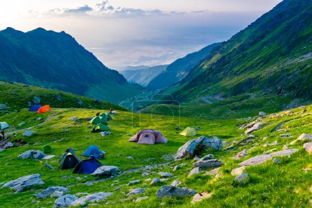 Tourist tents near the pass of Transfagarasan road, is one of most beautiful roads in world. Carpathians. Romania. Beautiful landscape of high mountains at sunset.