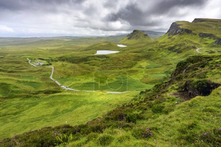 Photo for Beautiful,dramatic Scottish, Skye mountain scenery,jagged peaks,winding road and sheer cliffs, along the Quiraing hills walk,green course grass covered in mid summer,in the north east. - Royalty Free Image