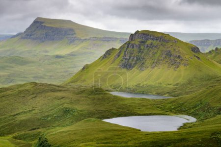 Photo for The Quiraing walking loop,beautiful,stunning,dramatic Scottish,Isle of Skye mountain scenery,jagged rocks and peaks,remains of ancient landslip, winding roads,sheer cliffs and lakes in mid summer. - Royalty Free Image
