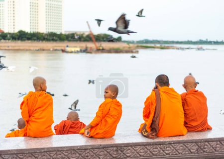 Photo for Phnom Penh,Cambodia-January 4th 2023: Monks of all ages from the nearby temples, mingle with the rest of the capital city's population,who come here in their droves to eat and relax,in the evening. - Royalty Free Image