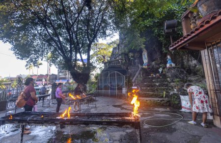 Photo for Dumaguete,Negros Island,Philippines-February 01 2023: Many religious Catholic devotees,residents or pilgrims,visit the sacred site daily,to give thanks and burn much incense,at the iconic landmark. - Royalty Free Image