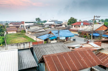 As dusk approaches,a beautiful,scenic,peaceful,yet expanding town,many small buildings,near the Myanmar border,surrounded by mountains,a haven for travelers,hippies and Thai tourists from Chiangmai.