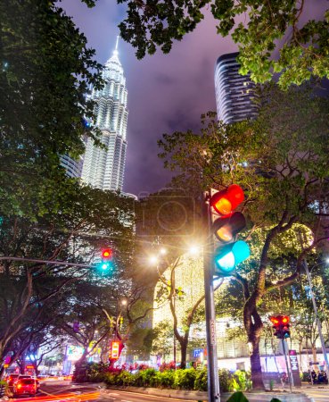 Téléchargez les photos : Kuala Lumpur, Malaisie-15 avril 2023 : Dans la capitale malaisienne, les lumières vives et colorées et le trafic achalandé continuent du crépuscule à l'aube, les nuages au-dessus rayonnant de la lumière intense ci-dessous. - en image libre de droit