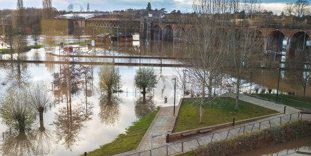Extreme weather conditions,extensive flooding,after heavy,prolonged rain and storms,high,overwhelming river water levels,swans swim in previously dry areas,roads cut off,flooded properties and roads.