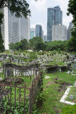 Photo for Tucked away off Jln Ampang and split from Kampung Baru by a highway is one of KL's oldest Muslim burial grounds. It's shaded by giant banyans and rain trees. - Royalty Free Image