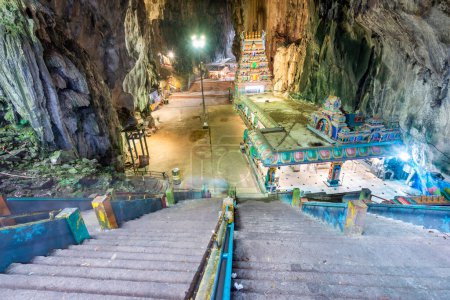 Visitors go through the tall cave entrance,down a flight of stairs,into the vast interior,to admire the beautiful temple structures,built in 1920,and natural splendour of the limestone cave complex.