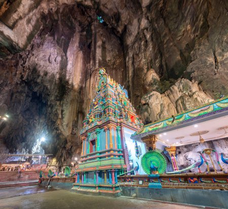 Visitors go through the tall cave entrance,down a flight of stairs,into the vast interior,to admire the beautiful temple structures,built in 1920,and natural splendour of the limestone cave complex.