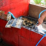 Grease traps from dirty debris being cleaned with a scoop are discarded. How to treat water with a grease trap.