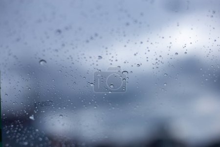 The textured background raindrops on the car's glass. Makes you feel cold and lonely, missing someone when traveling.