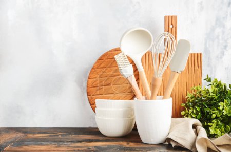 Foto de Background with kitchen utensils standing on wooden countertop. - Imagen libre de derechos