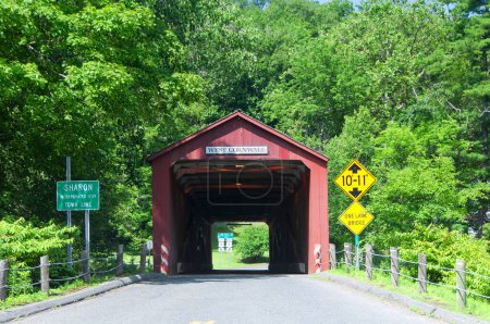 The landmark West Cornwall covered bridge over the Housatonic River in West Cornwall Connecticut in the summer.