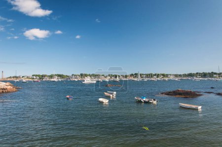 Boats moored offshore near Marblehead Lighthouse in marblehead Massachusetts.