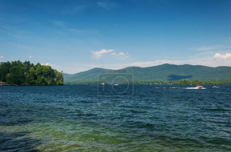 A landscape picture of the multi colors of Lake George in New York on a sunny summer day.