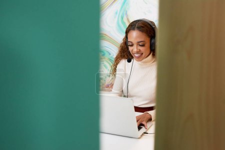 Photo for Shot of young office worker sitting in private booth, on remote call headset. High quality photo - Royalty Free Image
