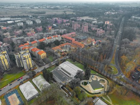 Photo for Cityscape aerial photography. Italian city view from a drone Sunset in cloudy weather, view from a drone of the city of San Donato Milanese, Milan, Italy. High quality photo - Royalty Free Image