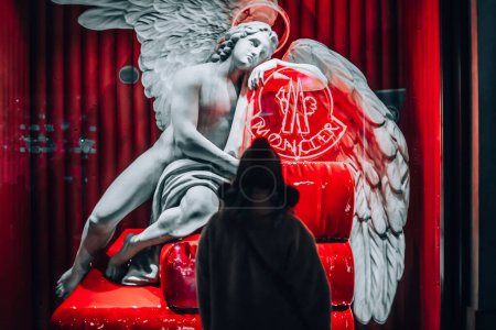 Photo for Moncler Italy Official Store. Shopping in Milan. Girl near a beautiful showcase Moncler in Milan Galleria Vittorio Emanuele. Italia, Milano 01.01.2024. - Royalty Free Image
