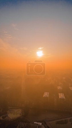 Foggy sunrise with San Donato Milanese Skyline from a drone, Lombardia, Milano, Italia 5.02.2024. High quality photo