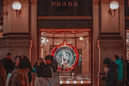 Photo for Milan, Italy 15.12.2023. Shop window in the center of Milan in the evening with many tourists. Shopping in Milan during the Christmas holidays. - Royalty Free Image