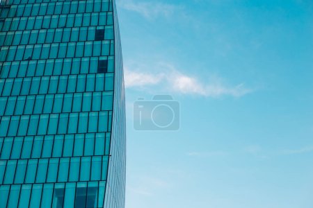 Background of facade of office building and blue sky. Glass buildings in Milan, Italy. CityLife Shopping District complex. Finance, economics, future concepts. 