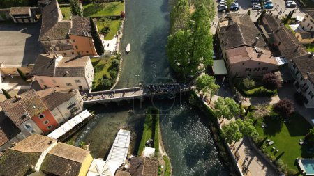 Beautiful panoramic top view of the mill village of Borghetto sul Mincio in the south of Lake Garda, in Veneto, Italy. Drone footage of the small medieval village