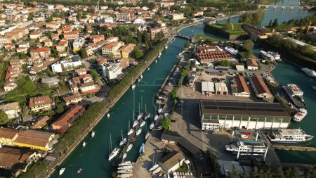 Aerial view of the city of Peschiera del Garda, Verona, Veneto. Top view of the canal with yachts. 