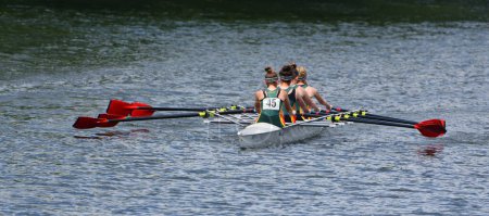Photo for ST NEOTS, CAMBRIDGESHIRE, ENGLAND - JULY 23, 2022: Ladies Fours Sculling Team Rowing on River. - Royalty Free Image