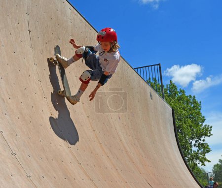 Photo for ST NEOTS, CAMBRIDGESHIRE, ENGLAND - JULY 03, 2022: Skateboarder on ramp  with strong shadow - Royalty Free Image