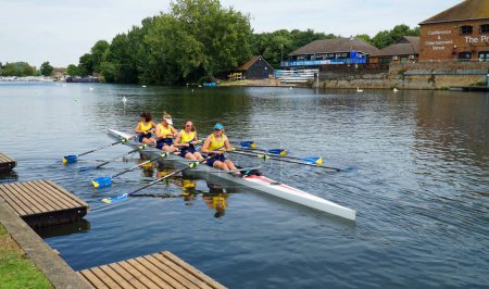 Photo for ST NEOTS, CAMBRIDGESHIRE, ENGLAND -  JULY 23, 2022: Ladies coxless fours on the river Ouse Cambridgeshire. - Royalty Free Image