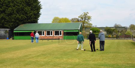 Photo for WRENBURY, CHESHIRE, ENGLAND -  APRIL 22, 2023: People playing Bowls on a sunny day. - Royalty Free Image