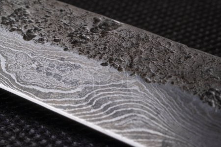 Background with a pattern of Damascus steel. Macro shot of damascusknife texture. Damascus steel with original pattern. Damascus steel pattern.