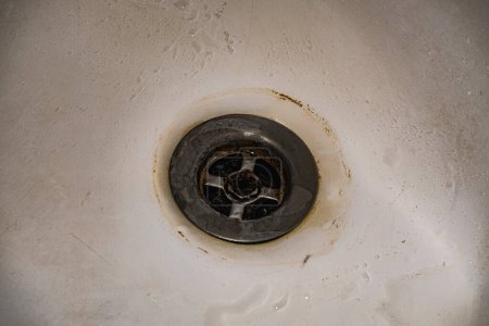 Photo for Dirt and scale collecting on and around the drain in the bathroom. - Royalty Free Image