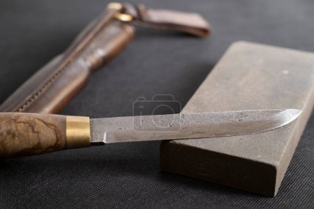 Photo for Damascus steel knife and knife sharpening stone - Royalty Free Image