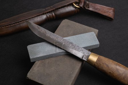 Photo for Damascus steel knife and knife sharpening stone - Royalty Free Image