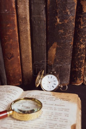 Photo for Gold pocket watch "Pavel Bure" on a gold pendant. Royal Russia. pocket watch on a dark background with books. Image of an antique gold pocket watch on an old antique book. - Royalty Free Image