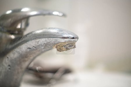 Foto de Bathroom faucet old dirty in plaque and rust, dirty water concept - Imagen libre de derechos
